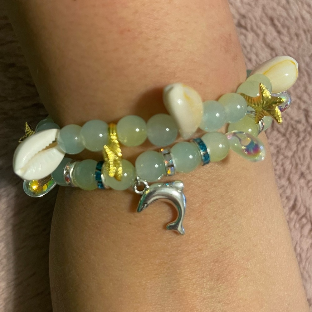 2pc beach shells and dolphin charms bracelets.